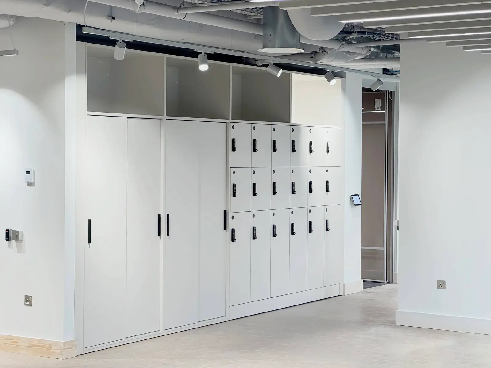 Fitted office storage and lockers designed by REFRAME in a London office