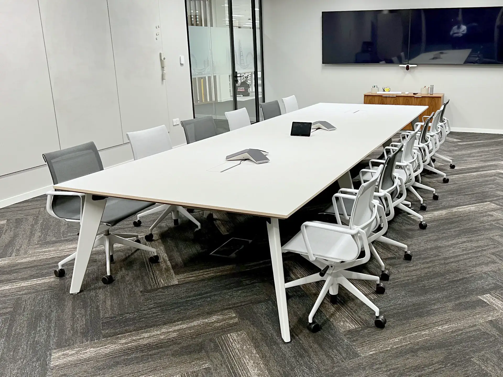 Bespoke Fenix boardroom table with painted legs and a custom frame, designed by REFRAME in London and built in Britain