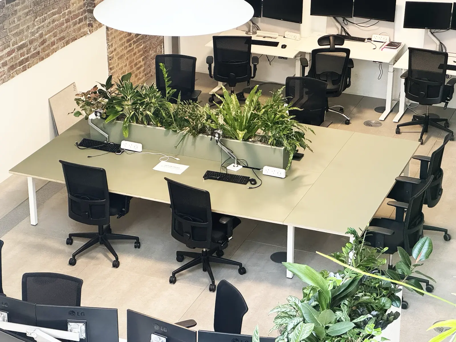 Bespoke Forbo top and planter designed to fit an existing desk frame, creating a breakout table